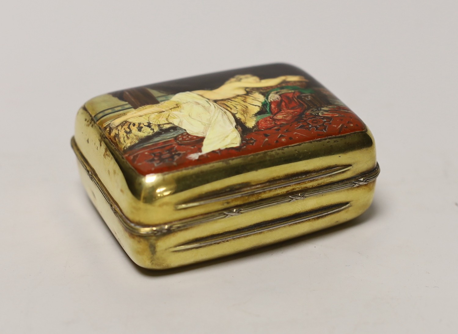 A George V silver gilt box and cover, by Albert Barker, London, 1913, the cover later? enamelled with a reclining nude, 90mm, gross weight 4.9 oz.